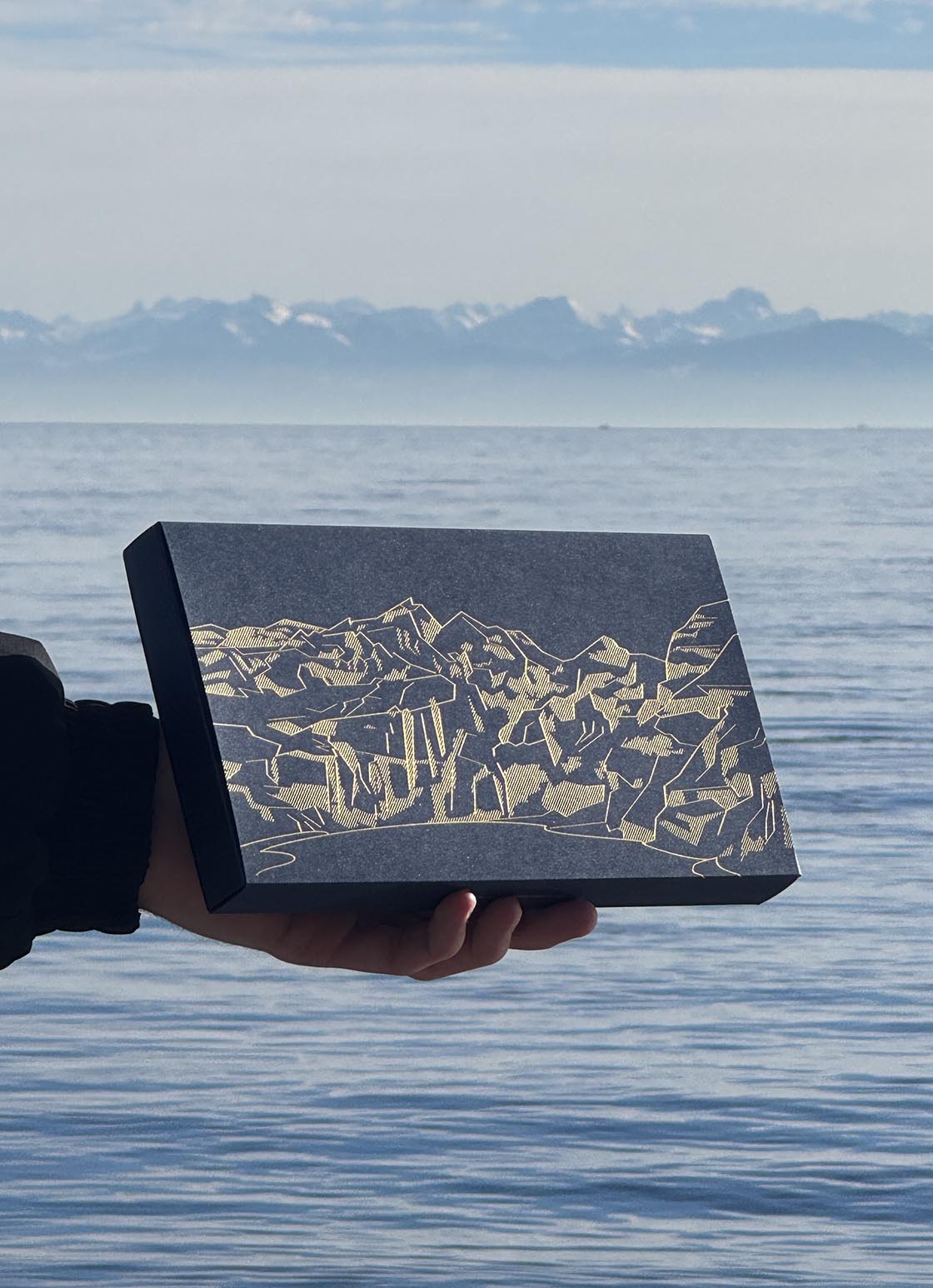 Packaging design – giveaway box in front of a mountain scenery